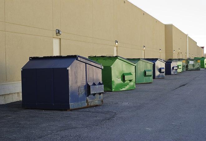 an assortment of sturdy and reliable waste containers near a construction area in Elmer